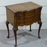 A walnut 2-drawer side table of small size, with shaped front and shell carved cabriole legs,