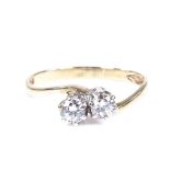 A 9ct gold 2-stone diamond crossover ring, total diamond content approx 0.3cts, maker's marks JM Co,