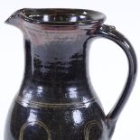 A large Winchcombe Studio Pottery jug, Tenmoku with combed decoration, pottery mark and maker's
