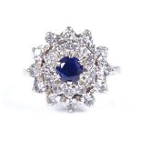 An 18ct white gold sapphire and white stone cluster ring, setting height 15.2mm, size M, 5g