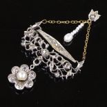 An unmarked silver and gold pearl and diamond pendant, with pearl set flower drop and pierced rose-