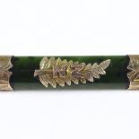 A New Zealand nephrite jade and 9ct gold-mounted brooch, with central fern decoration, length 57.