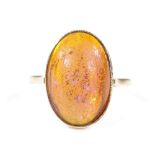An 18ct gold cabochon fire opal ring, opal measures 15.83mm x 10.72mm x 5.41mm, size L, 4.7g