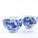 A pair of Chinese blue and white porcelain tea bowls of octagonal form, with hand painted carp