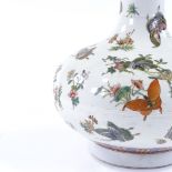 A Chinese porcelain narrow-necked vase, with hand painted butterflies and flowers, painted seal mark