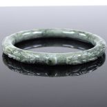 An Oriental carved nephrite bangle, internal diameter 64mm, 41.9g