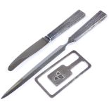 A sterling silver money clip, a silver-handled paper knife and matching caviar knife (3)
