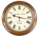 An early 20th century oak-cased railway dial clock, painted dial with 8-day movement, supplied by