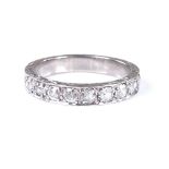 An 18ct white gold half eternity ring, with foliate engraved bridge, total diamond content approx