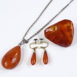 An amber pendant on silver chain, an amber brooch, and a pair of amber earrings (3)