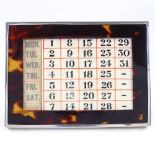 A rectangular silver and tortoiseshell-mounted desk calendar, with ivorine panelled back, by C&A,