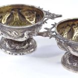 A pair of Victorian Scottish silver table salts, with elk-head handles and relief embossed game bird