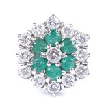 An unmarked white gold emerald and diamond cluster cocktail ring, total diamond content approx 1.