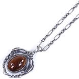 A Georg Jensen Danish sterling silver stone set pendant necklace, with stylised surround on original