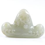 A Chinese relief carved jade calligraphy pen-rest, with wave designs, length 8cm