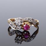 An unmarked gold ruby and diamond crossover ring, with rose-cut diamond shoulders, unmarked settings