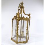 A French cast-brass framed hexagonal lantern light fitting, with glass panels, height 54cm