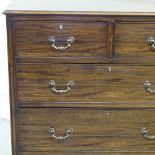 An Edwardian mahogany chest of 3 long and 2 short drawers, with brass drop handles and turned