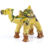 A Turkish Canakkale yellow glazed pottery camel, height 13cm, length 18cm