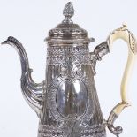 A George II silver hot water jug, of tapered form with intaglio fluted decoration, leaf design