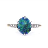 An 18ct gold black opal panel ring, with diamond set shoulders, opal measures 9.7mm x 7.72mm x 4.