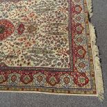 A Persian beige ground floral pattern rug, 10'1" x 6'7"