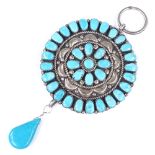 A large turquoise and silver circular pendant, possibly Mexican, with pear-shaped turquoise drop,