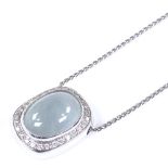 An 18ct white gold moonstone and diamond cluster pendant necklace, on 18ct gold chain, pendant