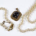 A silver-gilt Chinese stone set pendant, a silver-gilt pearl bracelet, and a long pearl strand