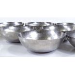 A set of 8 Keswick School of Industrial Arts planished metal bowls, impressed marks, serial number