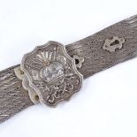 A Middle Eastern white metal mesh belt with armorial terminals, length 83cm