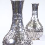 A large pair of late Victorian silver fluted vases, of bulbous form, with all over relief floral