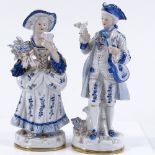 A pair of Continental blue and gilded porcelain figures, height 23cm