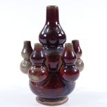 A Chinese Sang de Boeuf glaze triple gourd porcelain vase, with smaller gourd mounts, unmarked,