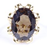 A large 14ct gold oval-cut smoky quartz dress ring, setting height 26.5mm, size N, 9.1g