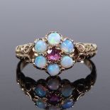 A 9ct gold opal and ruby cluster flowerhead ring, pierced and engraved shoulders, setting height