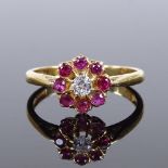 An 18ct gold ruby and diamond cluster flowerhead ring, setting height 9.1mm, size N, 2.9g