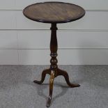 A 19th century circular mahogany dish-top wine table on tripod base, 19" across