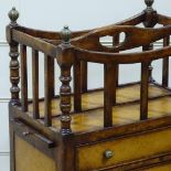 A good quality reproduction walnut Canterbury, with brass finials and leather-fronted drawers below