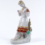 A Russian porcelain figure of a girl holding a flower, height 29cm