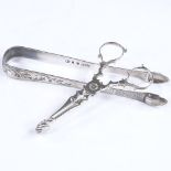 A pair of Georgian silver scissor sugar snaps, maker's marks WP, together with a pair of engraved