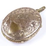A Victorian unmarked gold photo locket, with flower engraved front and back, height excluding bale