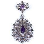 An Antique silver and amethyst drop pendant, with pierced open work settings and applied gold and