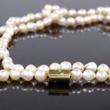 A single strand of opera pearls, with unmarked gold diamond set clasp, length 34"