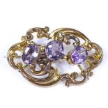 A Victorian unmarked gold and 3-stone amethyst brooch, with pierced open work foliate settings,
