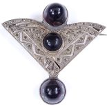 An Art Deco stylised silver fan brooch, set with 3 large cabochon amethyst stones and marcasites,