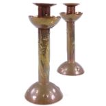 A pair of Newlyn Arts and Crafts copper candlesticks, with relief embossed fish decoration,