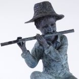 A patinated bronze sculpture of a boy playing a flute, height 54cm