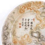 A Chinese porcelain plate with painted orange / black smoke decoration and text inscription,