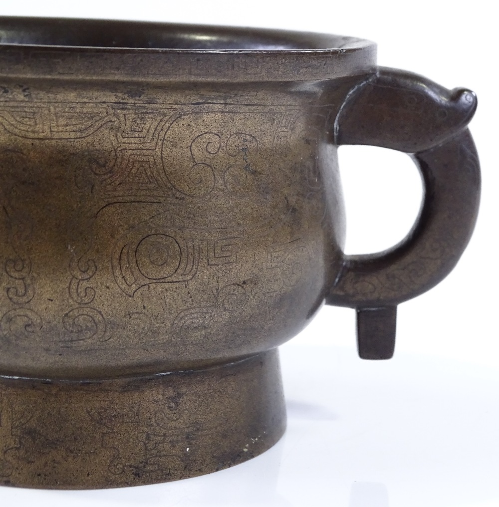A Chinese cast-bronze 2-handled incense burner with engraved geometric designs, rim diameter 12cm,